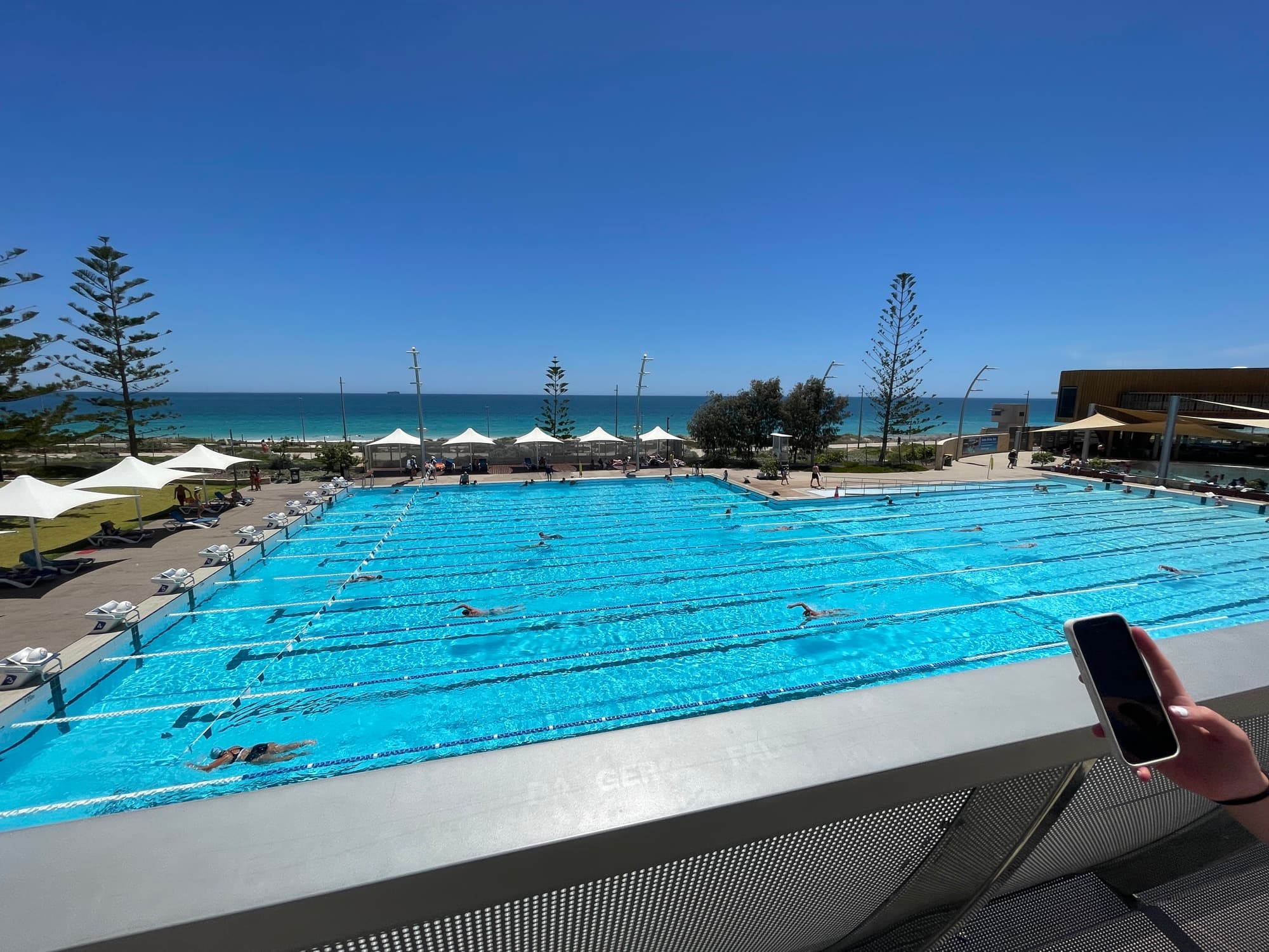 Outdoor pool lanes with swimmers, used as swimming context for PB Pathway.